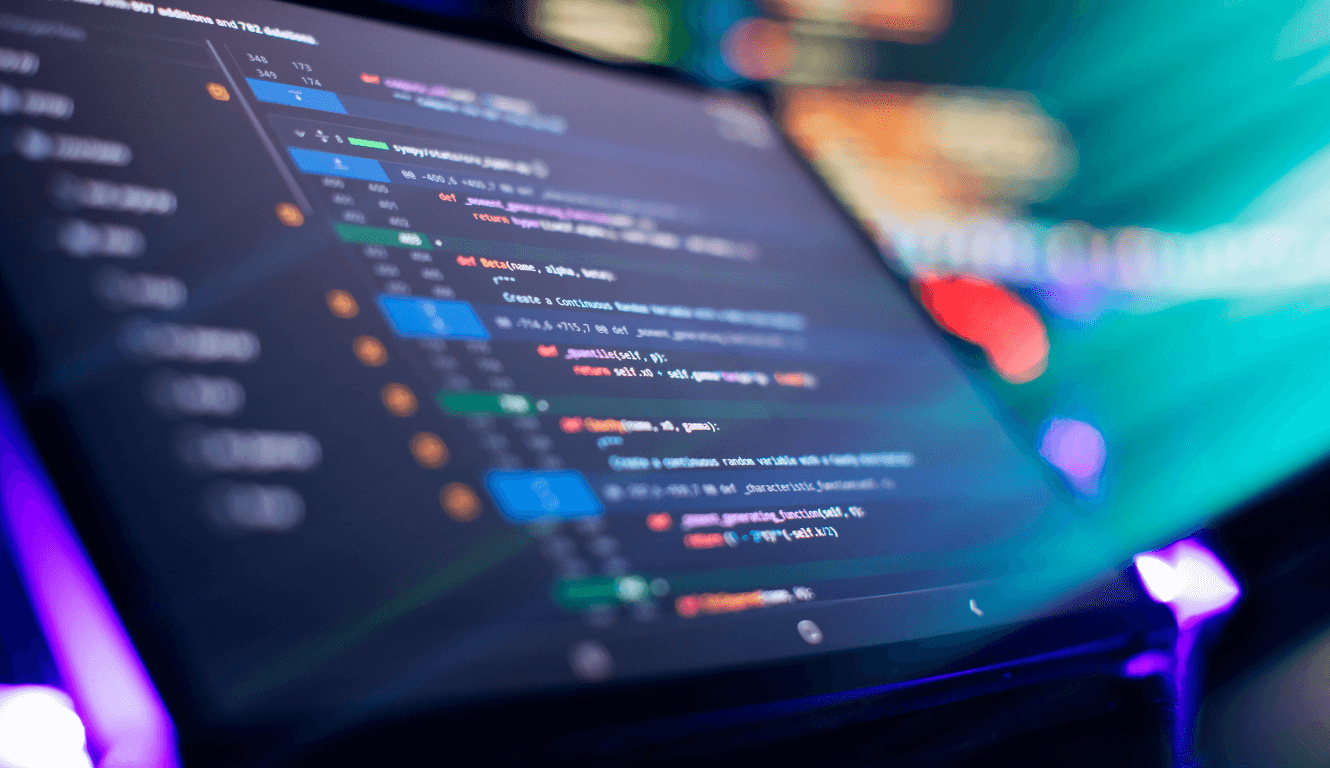 A glowing computer screen displays colorful lines of code in a dark setting, creating a futuristic and focused atmosphere, emphasizing technology and programming.