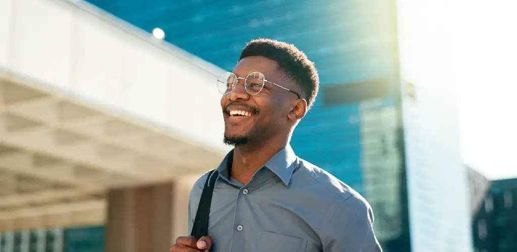 Smiling professional outside a modern office building representing a premium digital investor portal experience